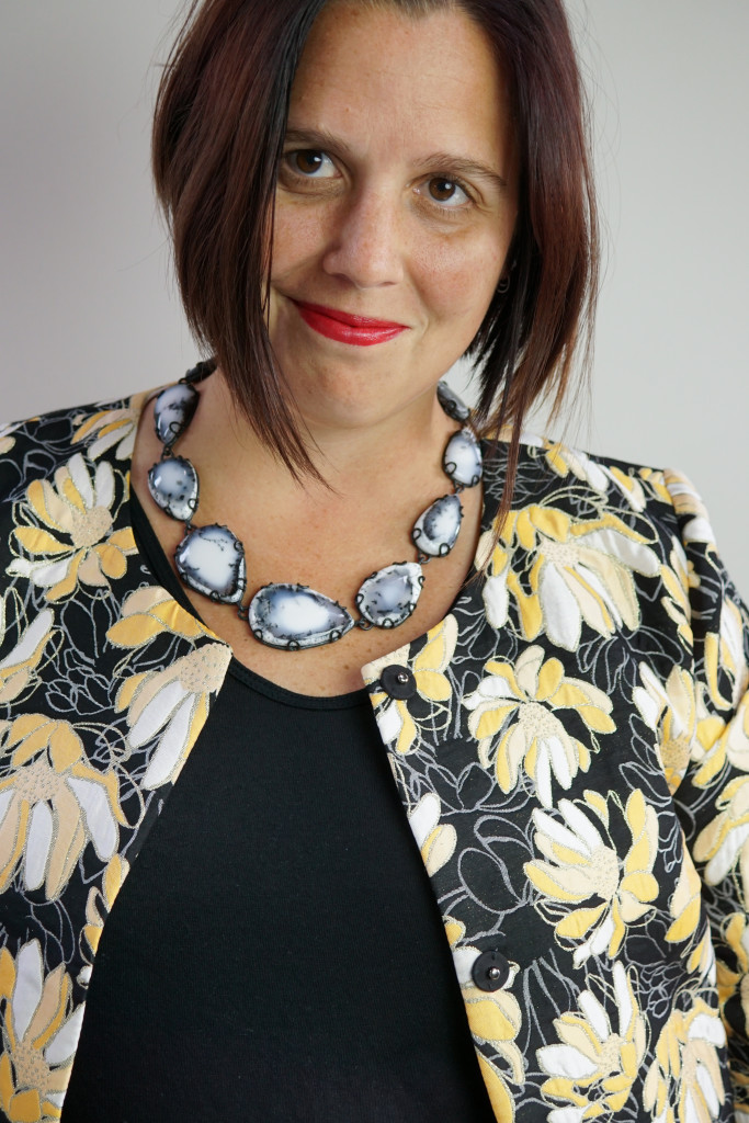 black and white gemstone statement necklace and floral patterned coat