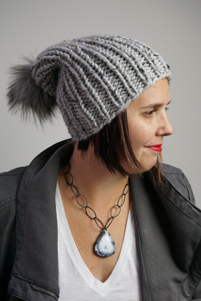 edgy and sweet winter style: knit hat, faux leather jacket, chunky amulet necklace
