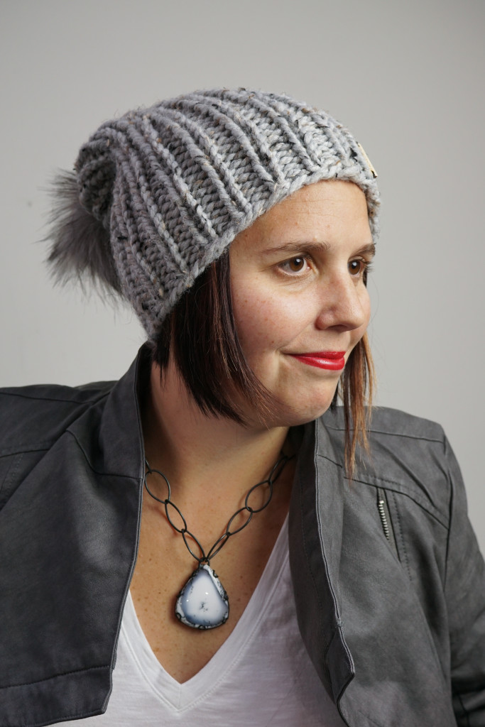 edgy and sweet winter style: knit hat, faux leather jacket, chunky amulet necklace