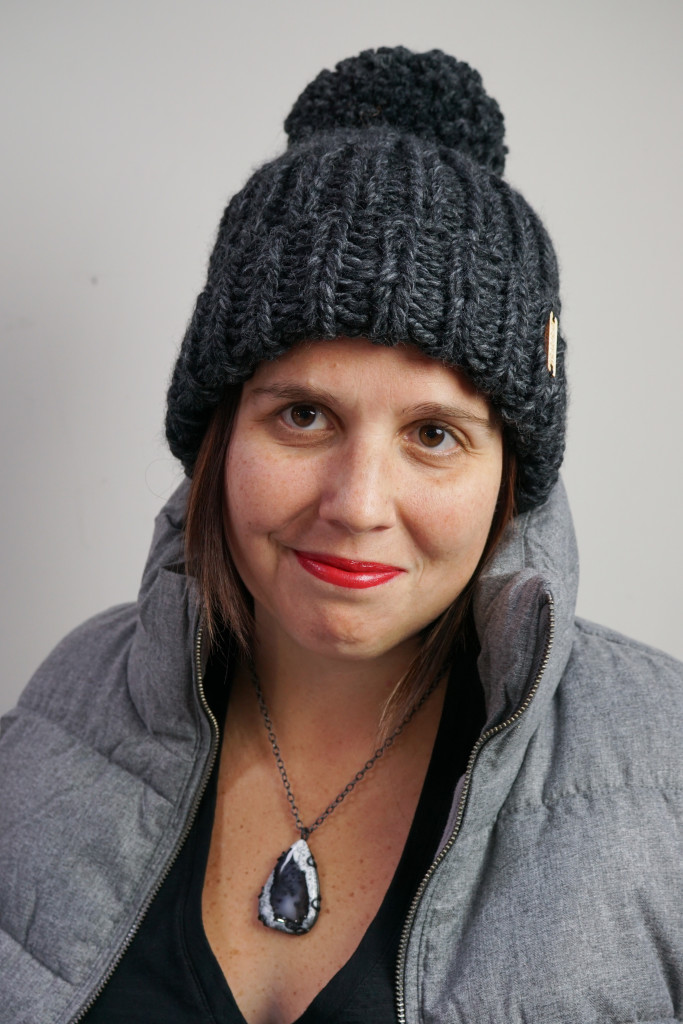 winter style: puffer vest, knit hat, and black gemstone necklace