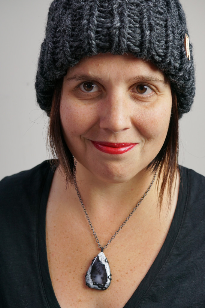 winter style: puffer vest, knit hat, and black gemstone necklace