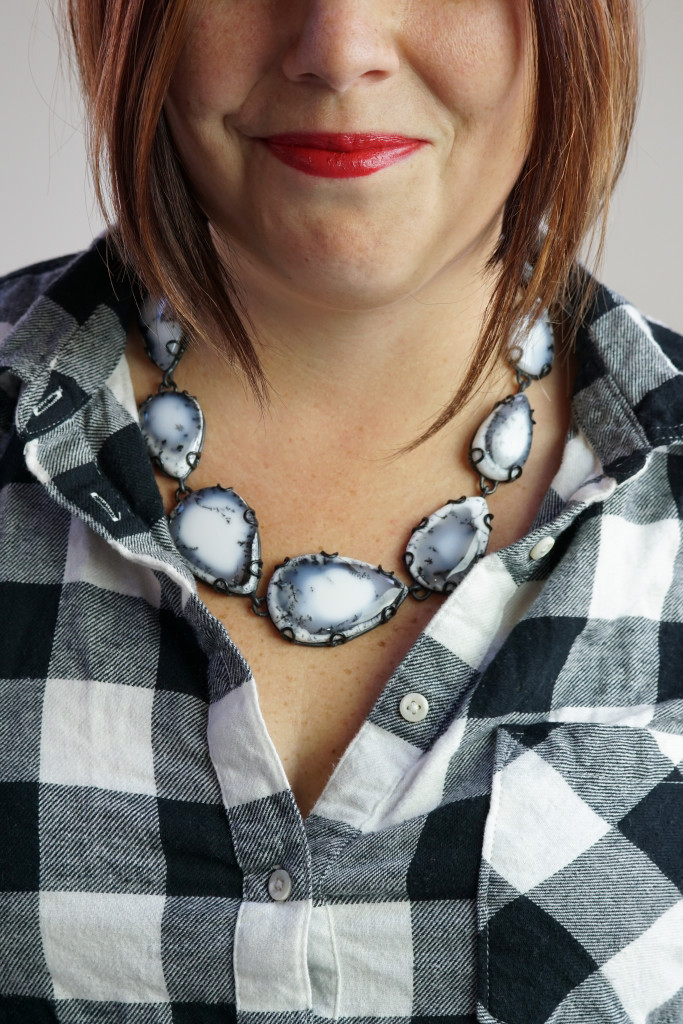 one of a kind gemstone statement necklace with black and white flannel shirt
