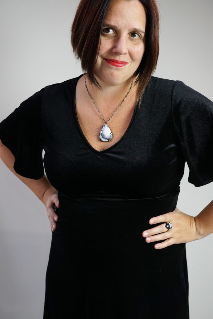 holiday party outfit: velvet little black dress and gemstone pendant necklace