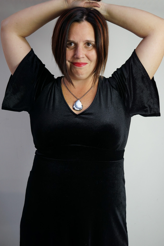 holiday party outfit: velvet little black dress and gemstone pendant necklace