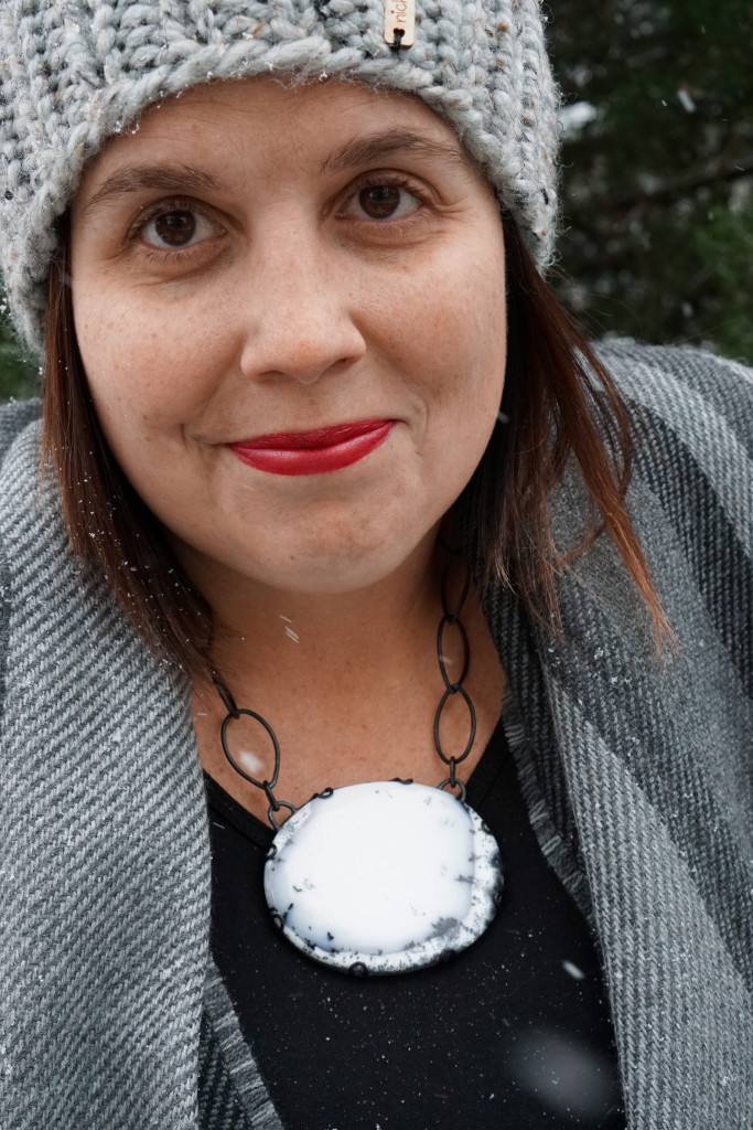 winter style: snowy winter portrait with black and white statement necklace