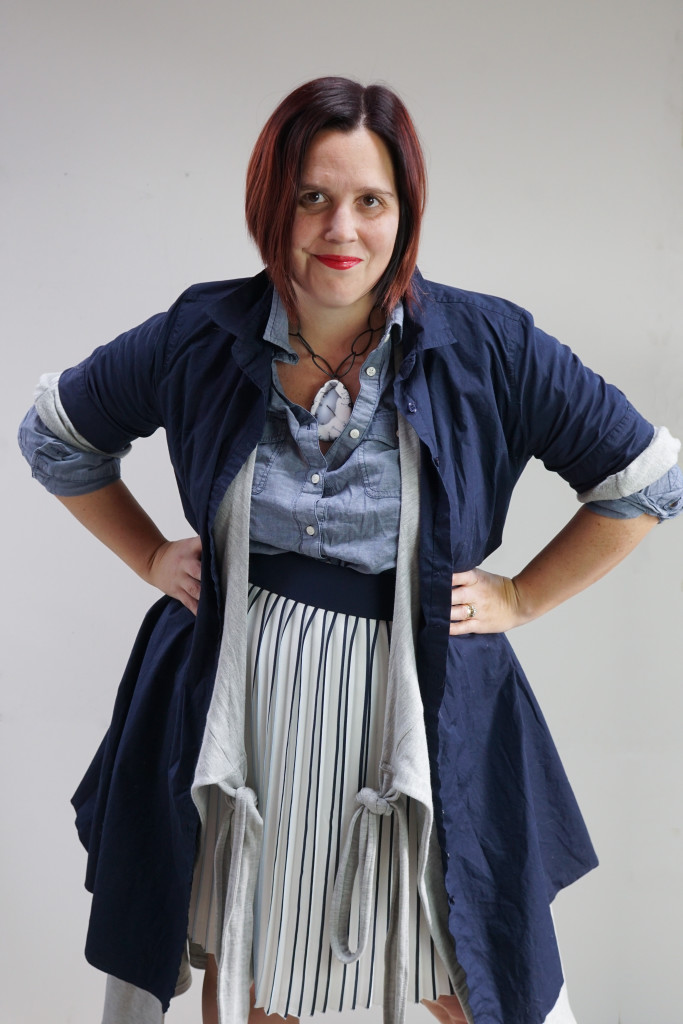 one dress thirty ways challenge, creative layering: shirt dress and wrap dress over pleated skirt and chambray shirt with bold gemstone necklace