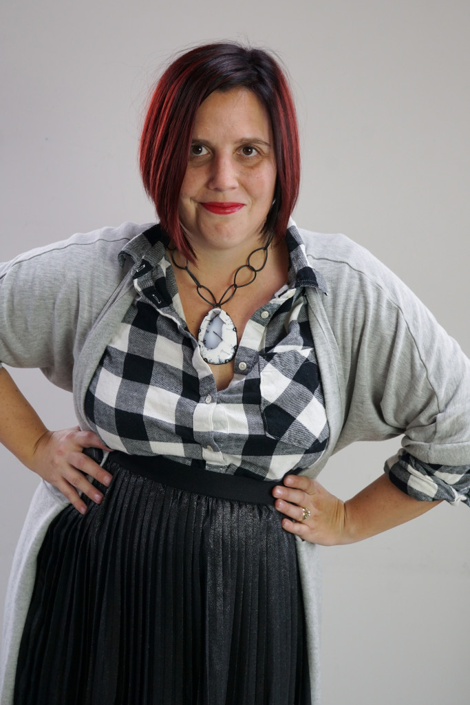 one dress, thirty ways creative style outfit inspiration: grey wrap dress as duster over black and white plaid shirt and black pleated skirt with giant gemstone statement necklace