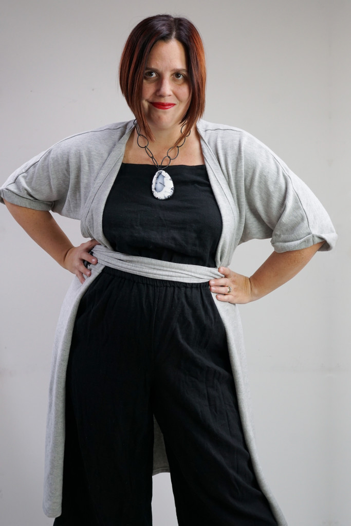 one dress, thirty ways outfit inspiration: grey wrap dress over black jumpsuit with chunky gemstone statement necklace