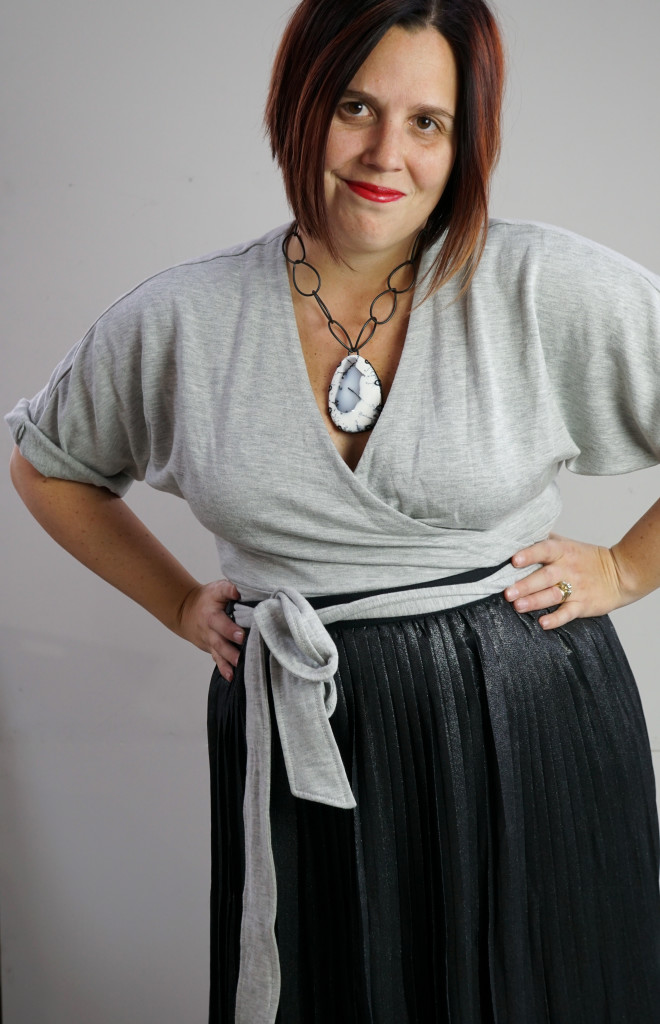 one dress, thirty ways style inspiration: inspired by late 50s, early 60s movie style: grey wrap dress, black pleated skirt, and chunky gemstone statement necklace (for a touch of attitude)