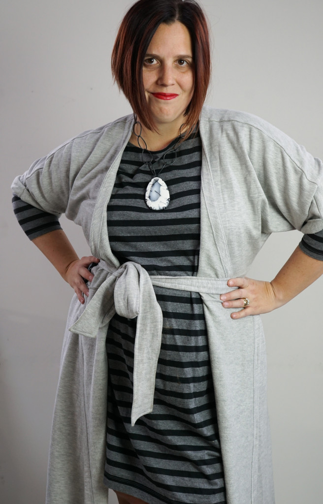 one dress thirty ways style challenge: grey wrap dress over grey and black striped dress with chunky gemstone statement necklace