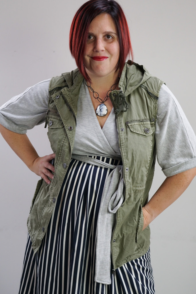 one dress challenge, creative outfit ideas: military vest over wrap dress and striped skirt with chunky gemstone necklace