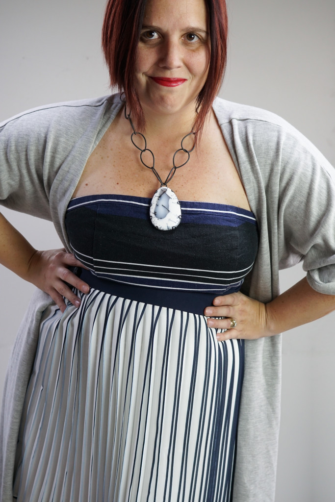 one dress thirty ways outfit inspiration: grey wrap dress over pleated skirt and strapless dress with chunky amulet necklace