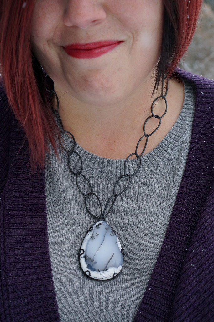 casual winter style: layered sweaters and chunky gemstone statement necklace