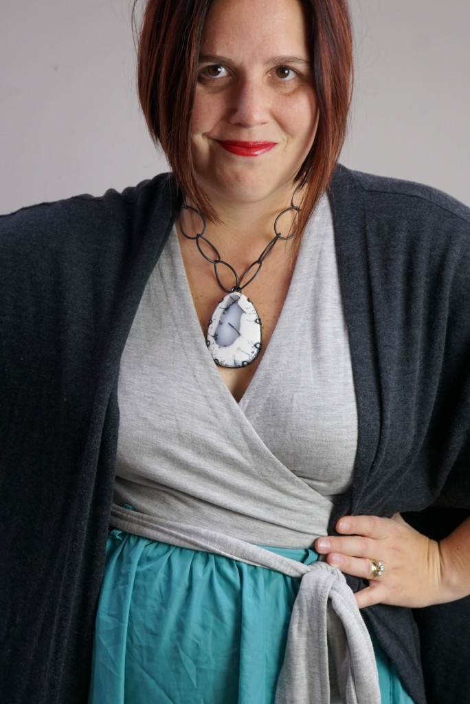 one dress, thirty ways style inspiration: playing with layers with a grey wrap dress, aqua skirt, charcoal cardigan, and chunky gemstone statement necklace
