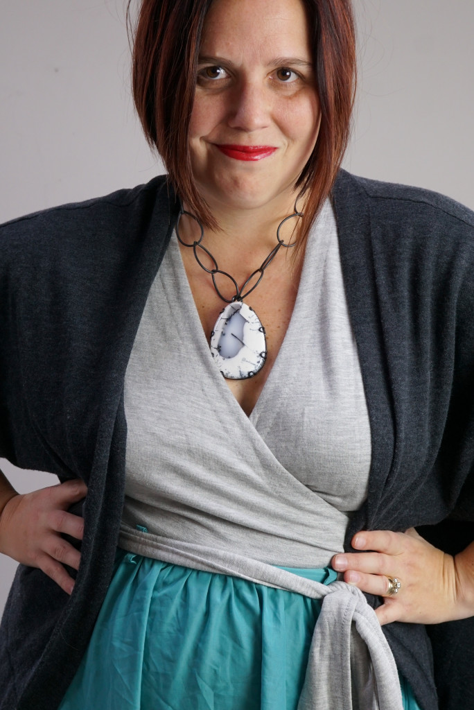 one dress, thirty ways style inspiration: playing with layers with a grey wrap dress, aqua skirt, charcoal cardigan, and chunky gemstone statement necklace