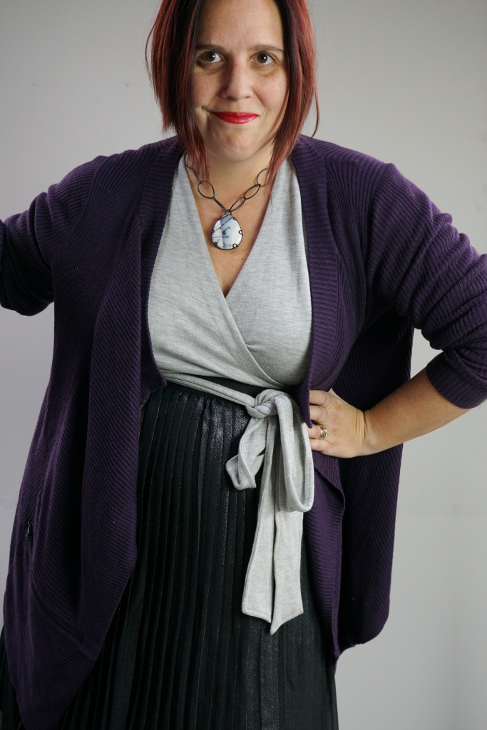 one dress thirty ways creative outfit inspiration: grey wrap dress, black metallic skirt, oversized purple cardigan, and chunky gemstone necklace