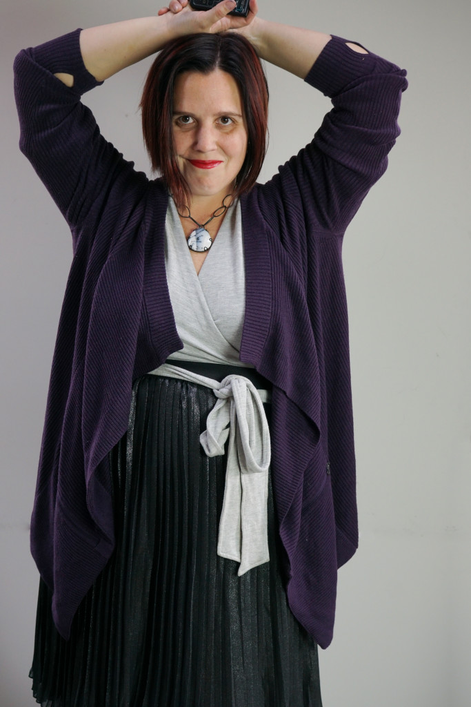 one dress thirty ways creative outfit inspiration: grey wrap dress, black metallic skirt, oversized purple cardigan, and chunky gemstone necklace