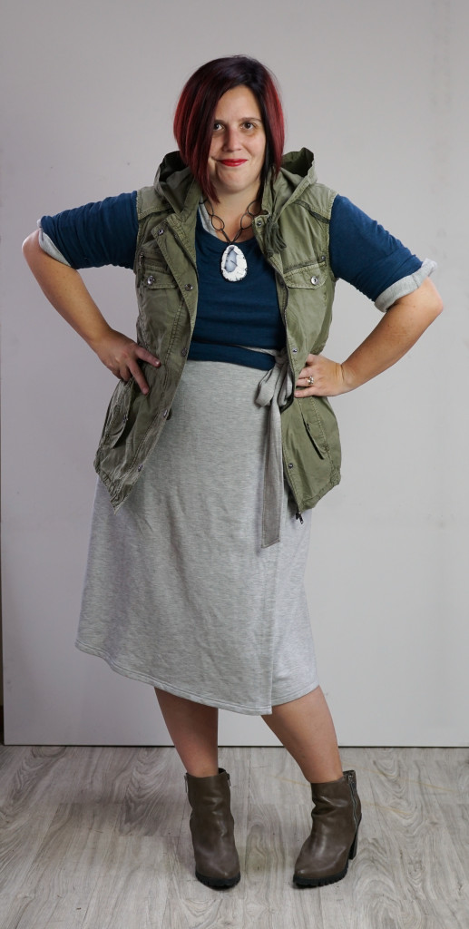 one dress, thirty ways style inspiration: military utility vest outfit over sweater and wrap dress with chunky gemstone necklace and boots