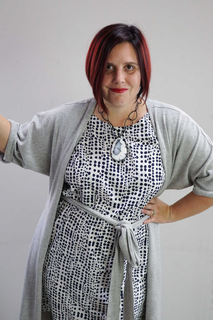 one dress thirty ways outfit inspiration: wearing a wrap dress as a duster and a big gemstone necklace over a patterned dress 