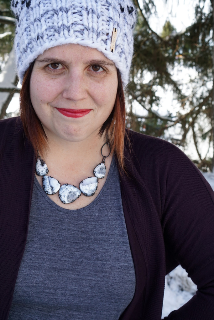 black and white statement necklace with cozy cardigan and knit hat