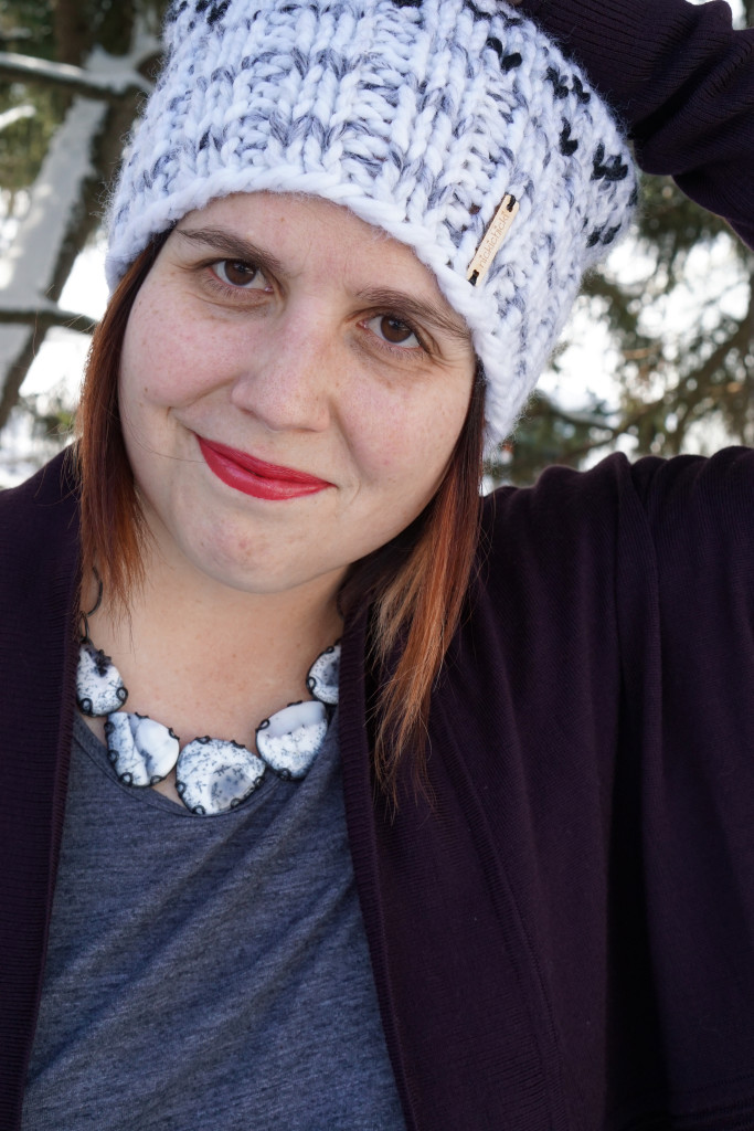 black and white statement necklace with cozy cardigan and knit hat
