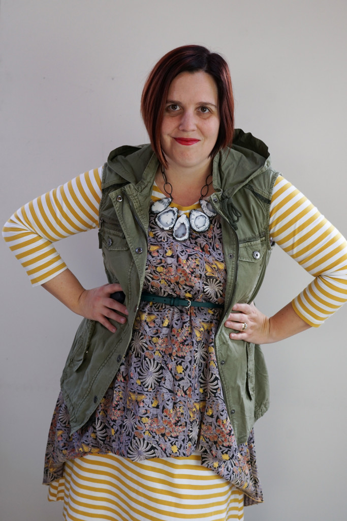 creative outfit ideas, pattern mixing: military jacket and floral dress over striped midi dress