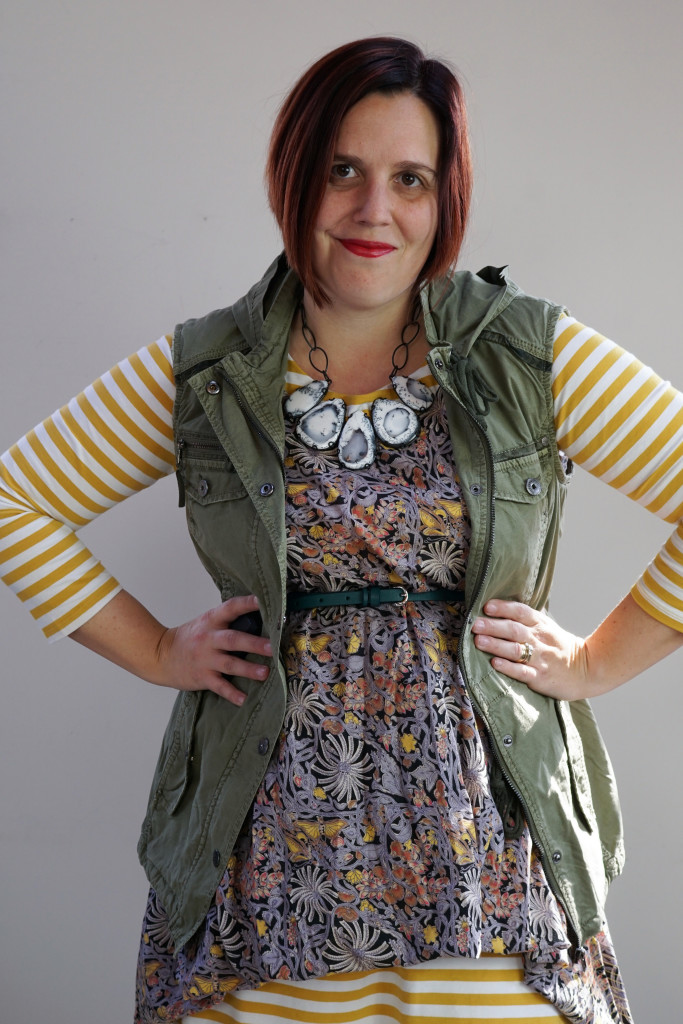 creative outfit ideas, pattern mixing: military jacket and floral dress over striped midi dress