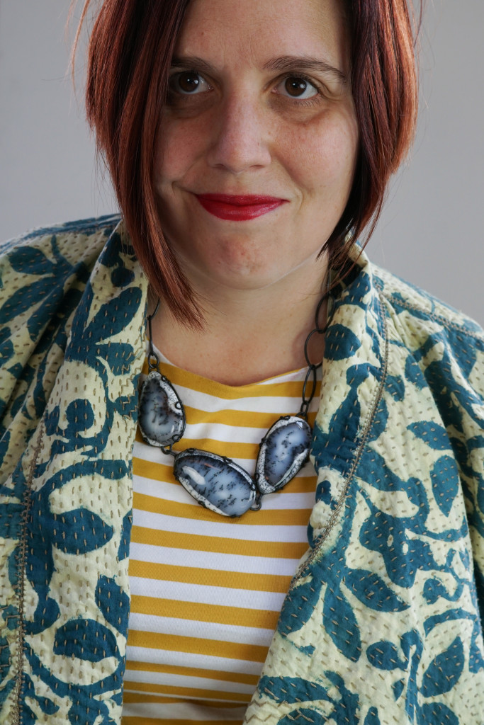 creative outfit ideas: block print embroidered jacket over striped midi dress