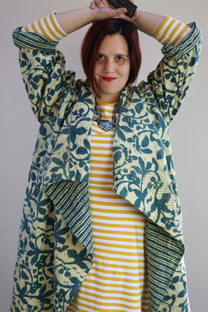 creative outfit ideas: block print embroidered jacket over striped midi dress
