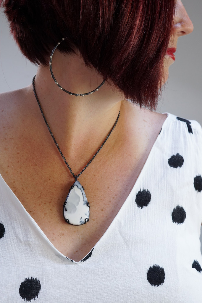 black and white summer style jewelry: giant hoop earrings, gemstone necklace, and black and white polka dot ikat dress