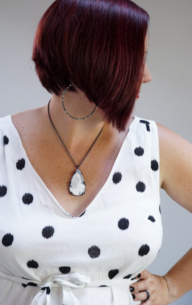 black and white summer style jewelry: giant hoop earrings, gemstone necklace, and black and white polka dot ikat dress