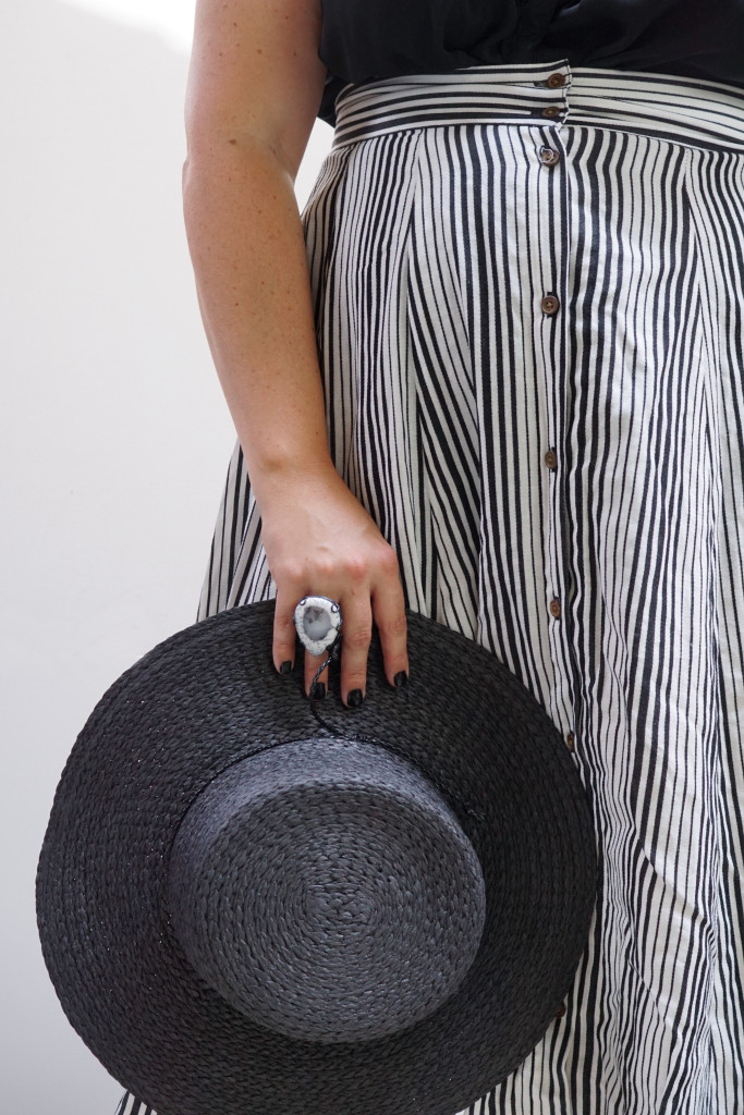 black and white summer style: striped skirt, straw hat, and statement ring