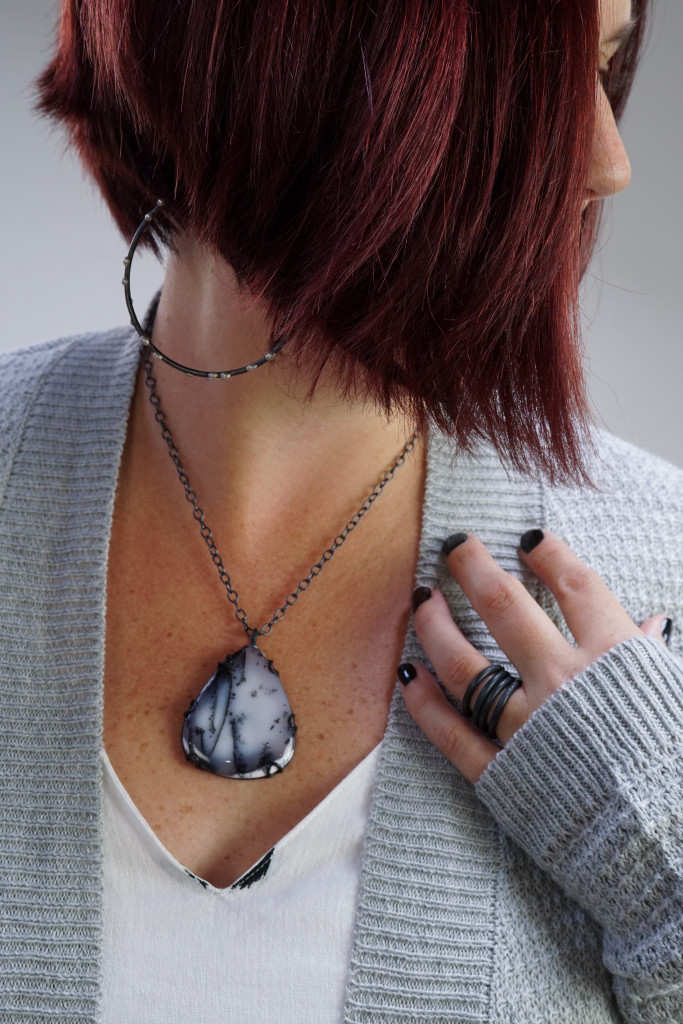 cozy fall style: cardigan, hoop earrings, gemstone necklace, and black stacking rings