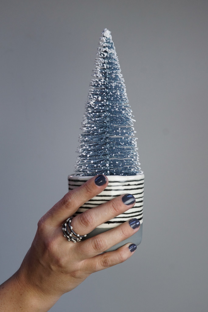 modern holiday decor: faux tree in handmade ceramic cup with silver on steel stacking rings