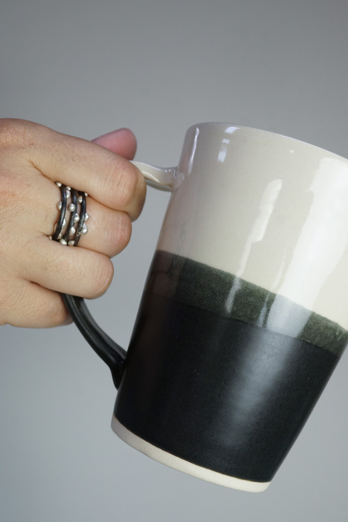 handmade ceramic mug by Bella Joy Pottery and silver on steel unique handmade mixed metal stacking rings by Megan Auman