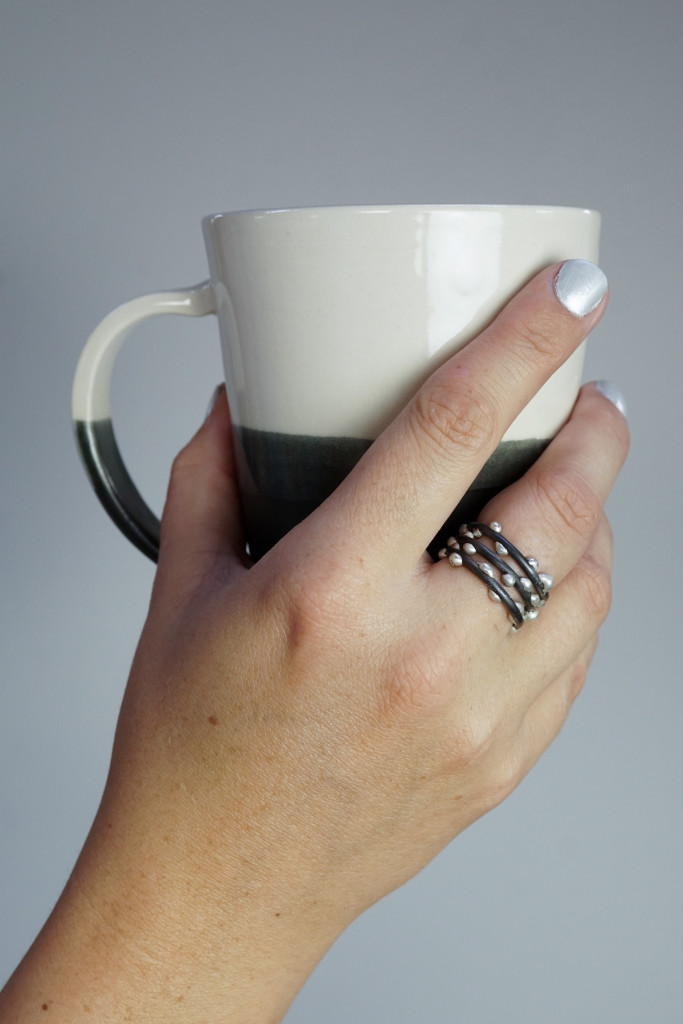 handmade ceramic mug by Bella Joy Pottery and silver on steel unique handmade mixed metal stacking rings by Megan Auman