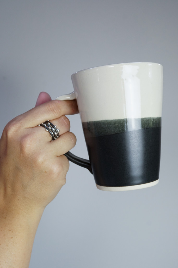 handmade ceramic mug by Bella Joy Pottery and silver on steel unique handmade mixed metal stacking rings by Megan Auman