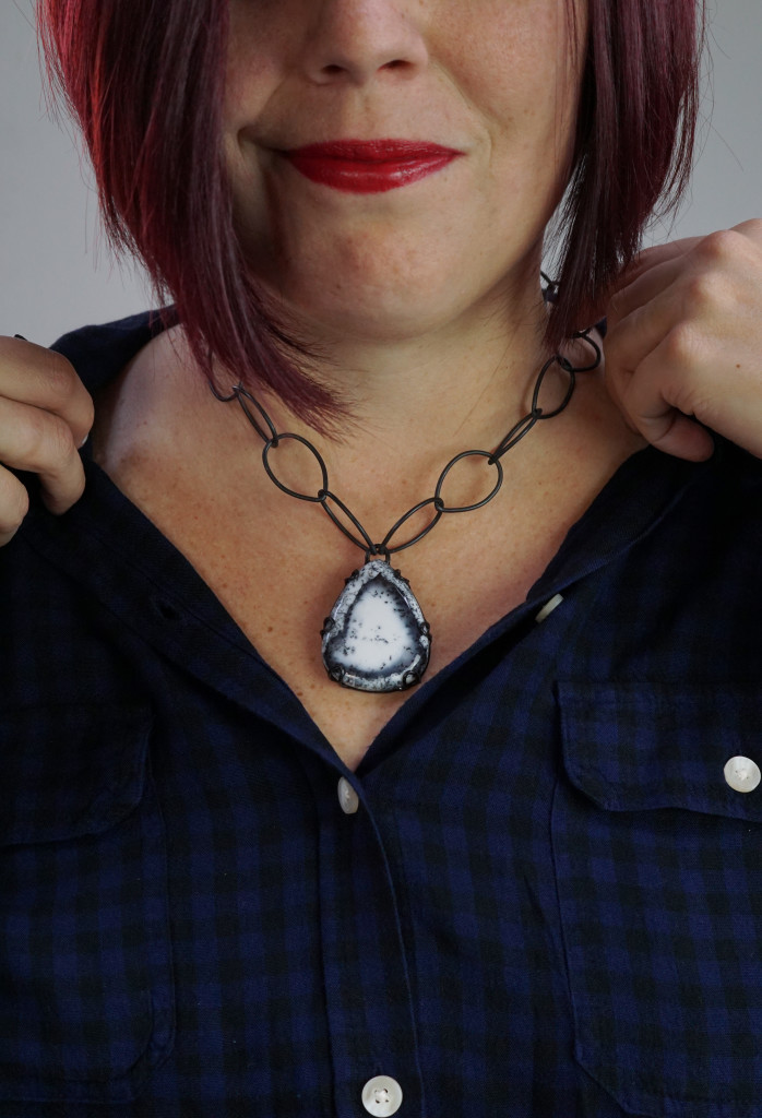 casual fall holiday style: black and navy plaid shirt with chunky gemstone statement necklace