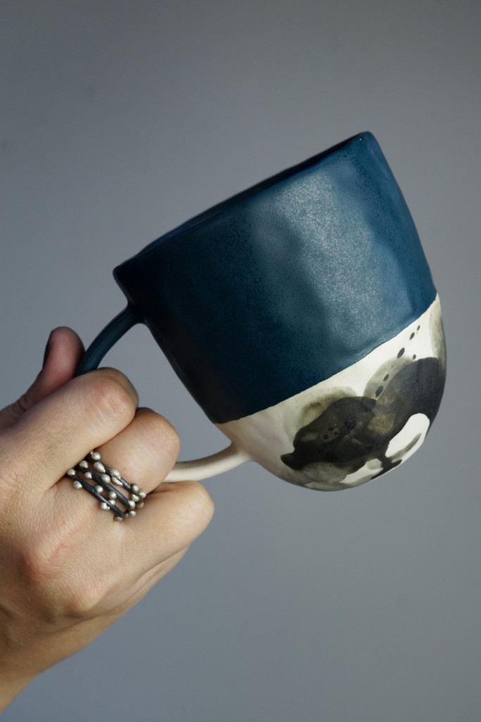 handmade ceramic mug and mixed metal silver on steel stacking rings