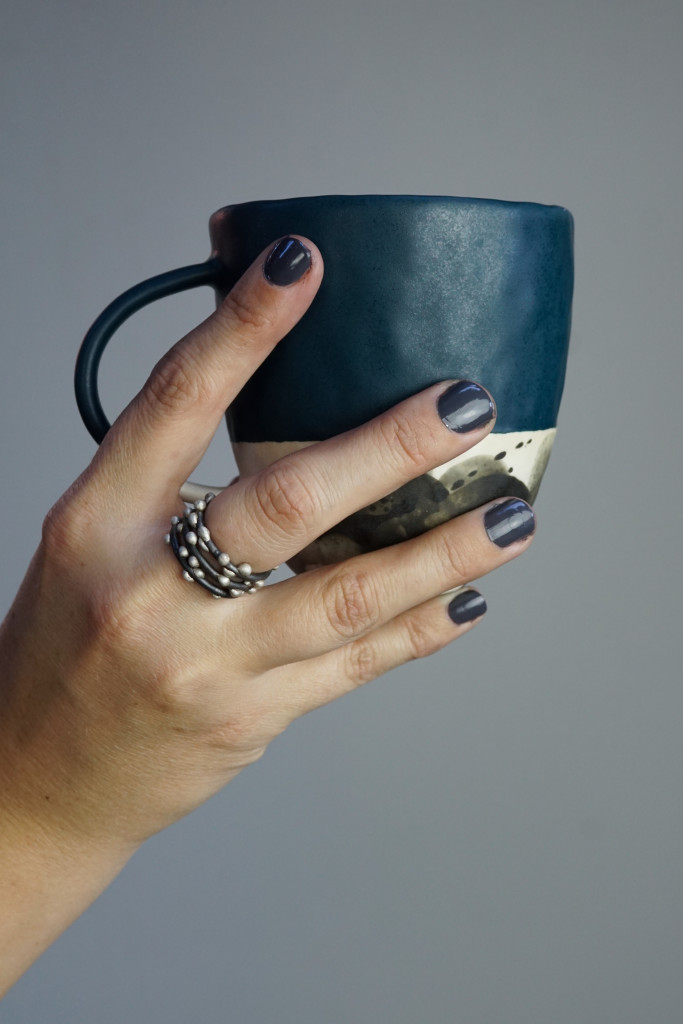 handmade ceramic mug and mixed metal silver on steel stacking rings