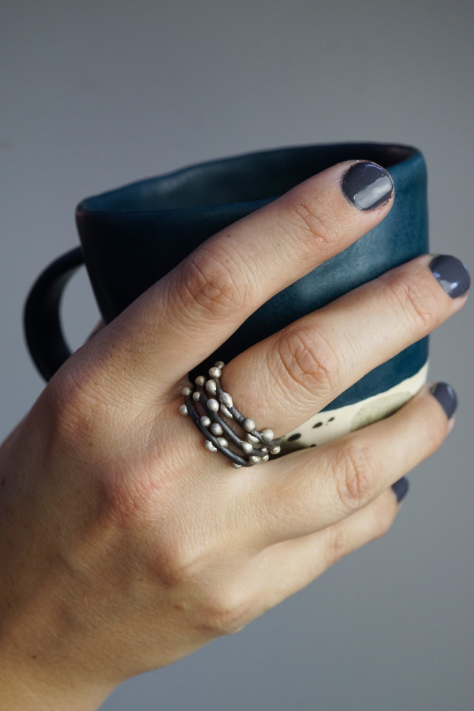 handmade ceramic mug and mixed metal silver on steel stacking rings