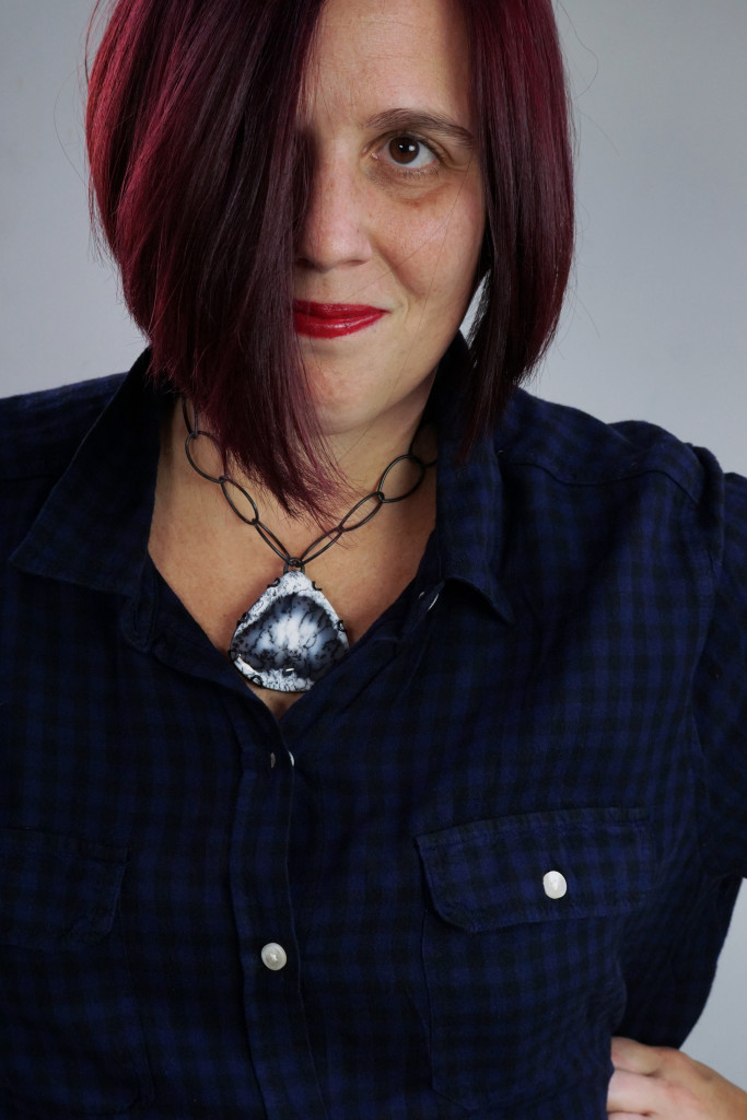 casual fall holiday style: black and navy plaid shirt with chunky gemstone statement necklace