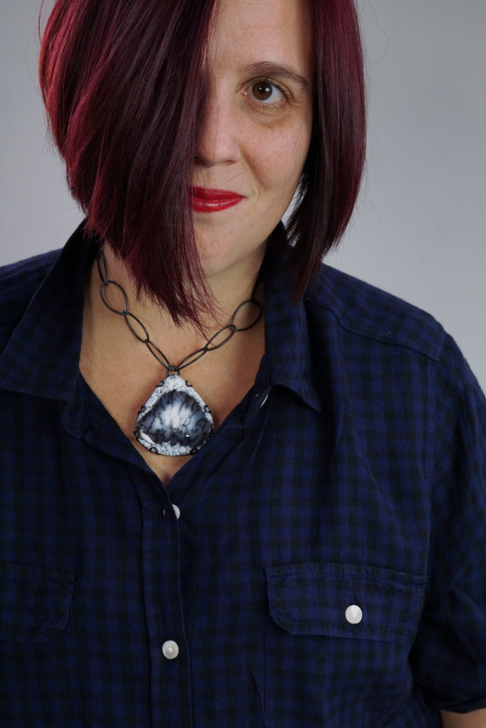 casual fall holiday style: black and navy plaid shirt with chunky gemstone statement necklace