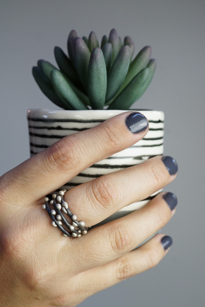 succulent, striped handmade cup, and mixed metal stacking rings