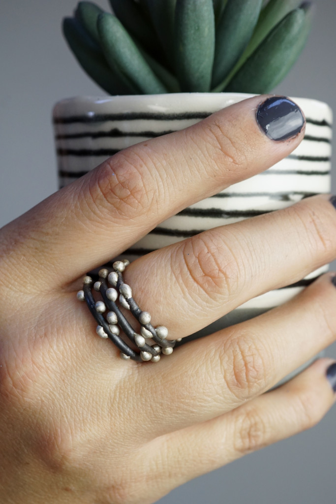 succulent, striped handmade cup, and mixed metal stacking rings