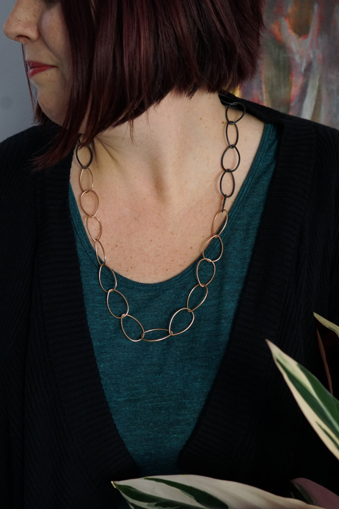 casual style: mixed metal bronze and black classic chain link necklace with t-shirt and cardigan