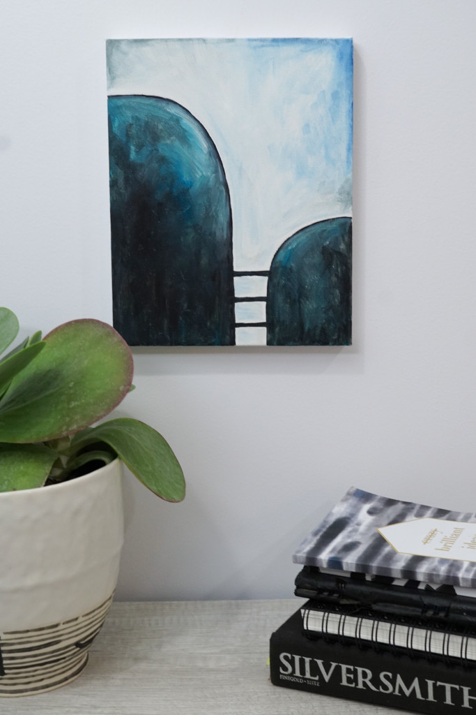 abstract art painting displayed with plant and books