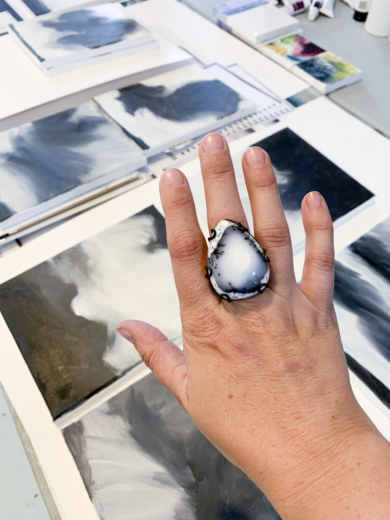 black and white gemstone statement ring and black and white paintings