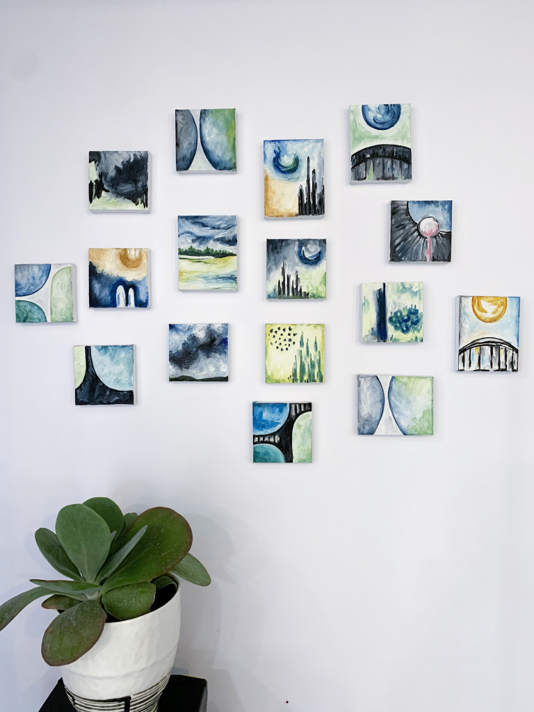 gallery wall with plant and tiny oil paintings