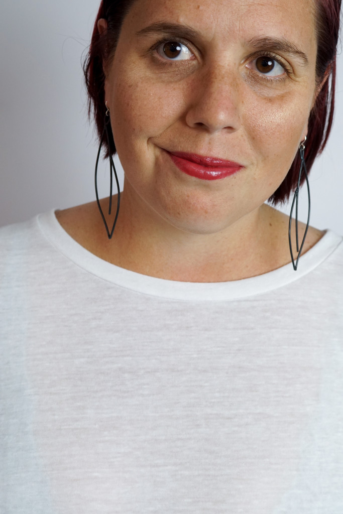 black statement earrings with white t-shirt and red lipstick